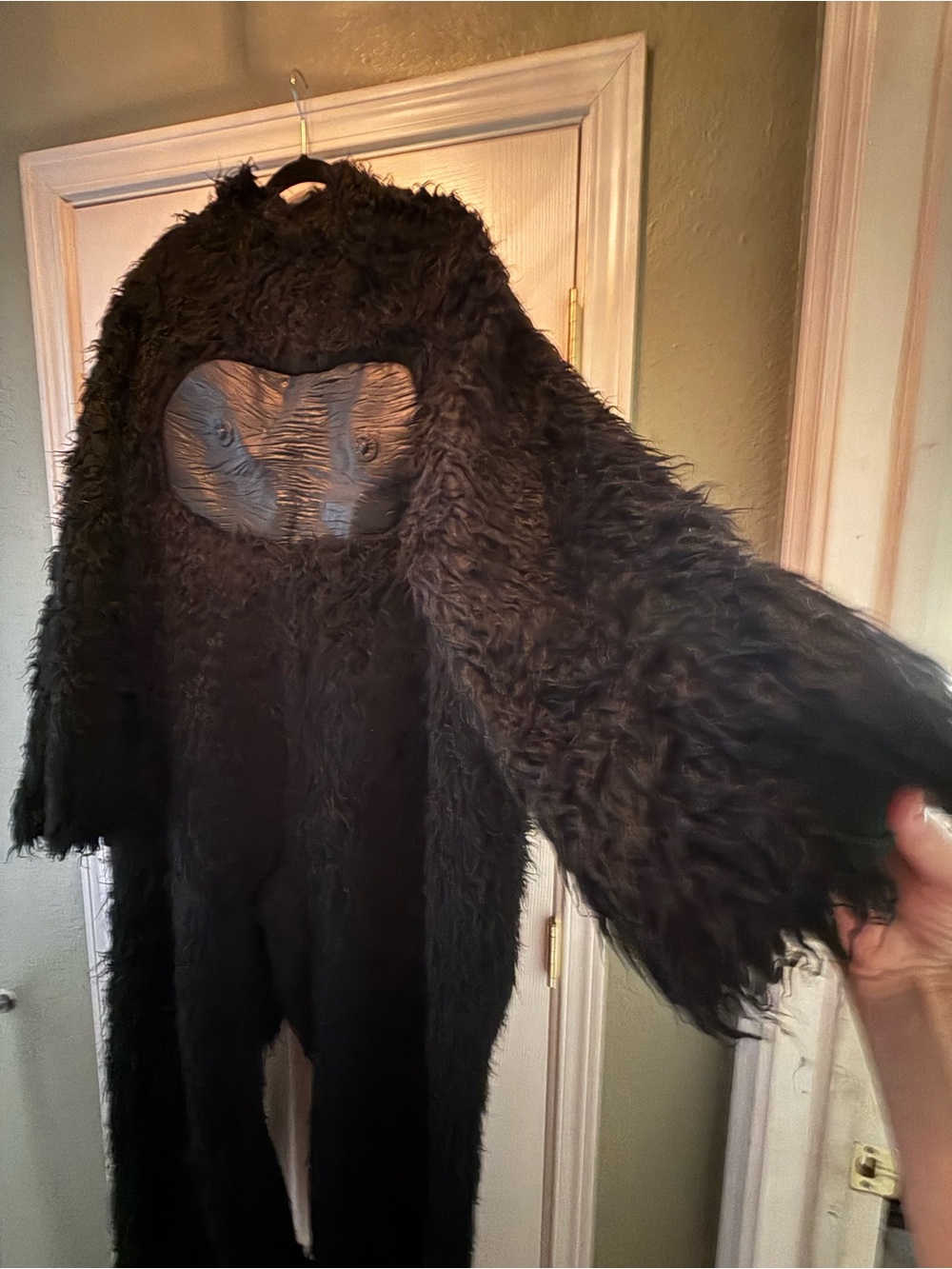 A black faux-fur gorilla or ape costume jumpsuit featuring a molded chest.